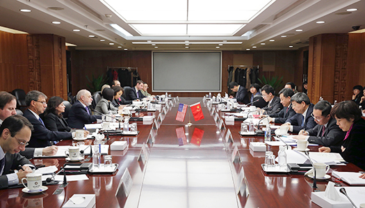 U.S. and China officials seated in the conference room for the meetings